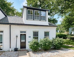 A two-story house with a dark front door, a mailbox, and a number '719' on the wall. - St. Charles 1860's Gem - Sleeps 6! (St Charles)