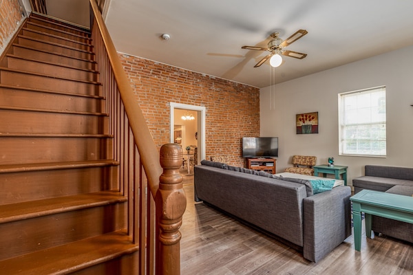 Beautiful wood stairway to two upstairs bedrooms.