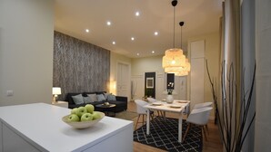 Un salon moderne comprenant un coin repas, un canapé et une table avec des chaises.