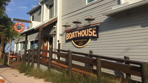 A building with a sign reading "BOATHOUSE RESTAURANT and BAR" and a lifebuoy sign above the entrance. - Roonie's Periwinkle Cottage -  waterfront- 2 bikes - downtown Stuart (Stuart)