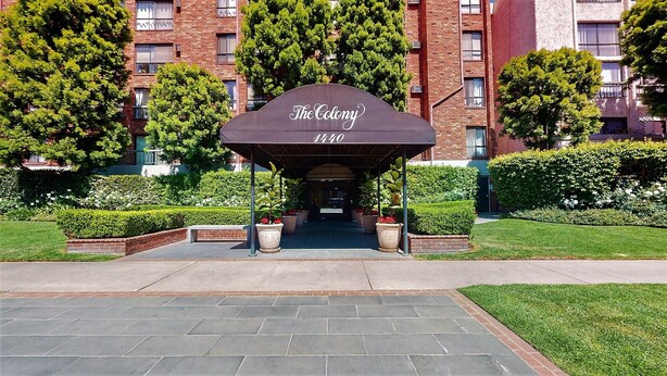 The Colony at 1440 with a covered entrance, brick building, and well-maintained landscaping. - Centrally Located Modern Luxury, Walking Distance to UCLA, Westwood (Los Angeles)