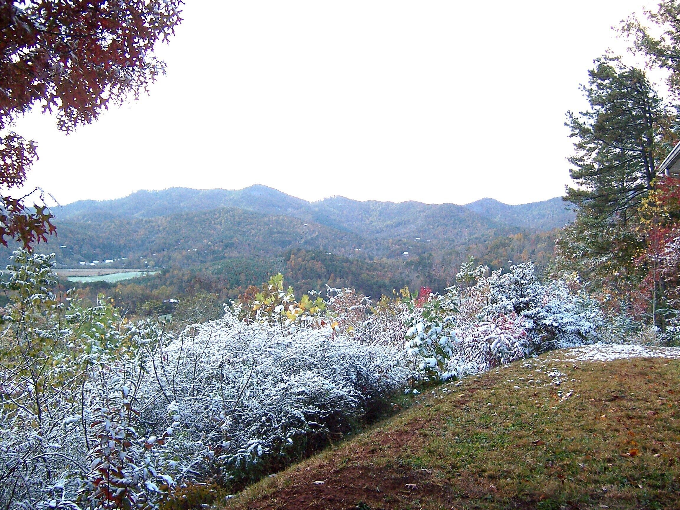 A mountainous landscape with a valley and a river.