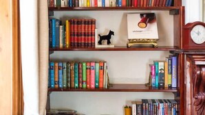 Une bibliothèque contenant divers ouvrages et un petit objet décoratif.