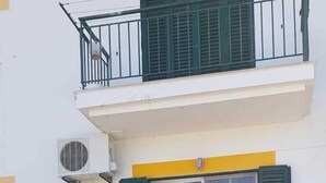 A two-story building with a balcony, a staircase, and a covered entrance. - Apartment in residence (Altura)