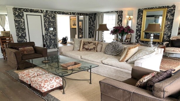 A living room with a sofa, two armchairs, a glass coffee table, and a patterned rug. - Miner Cottage-Historic Antique Home just steps from the Equinox Resort (Manchester)