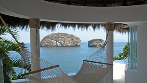 A hammock in a room with a view of the sea and cliffs. - Great RATES with full STAFF!  Relax and enjoy! (PUERTO VALLARTA)