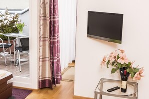 Relax in a stylish room with a flat-screen TV, comfortable seating area, and a large window with a view.
