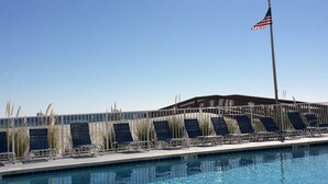 A swimming pool with lounge chairs and an American flag. - The Leeway,  Beautiful Gulf Front Condo on the Gulf of Mexico (Gulf Shores)