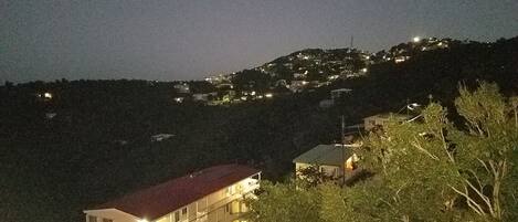 A hillside residential area with houses and a building with a red roof.