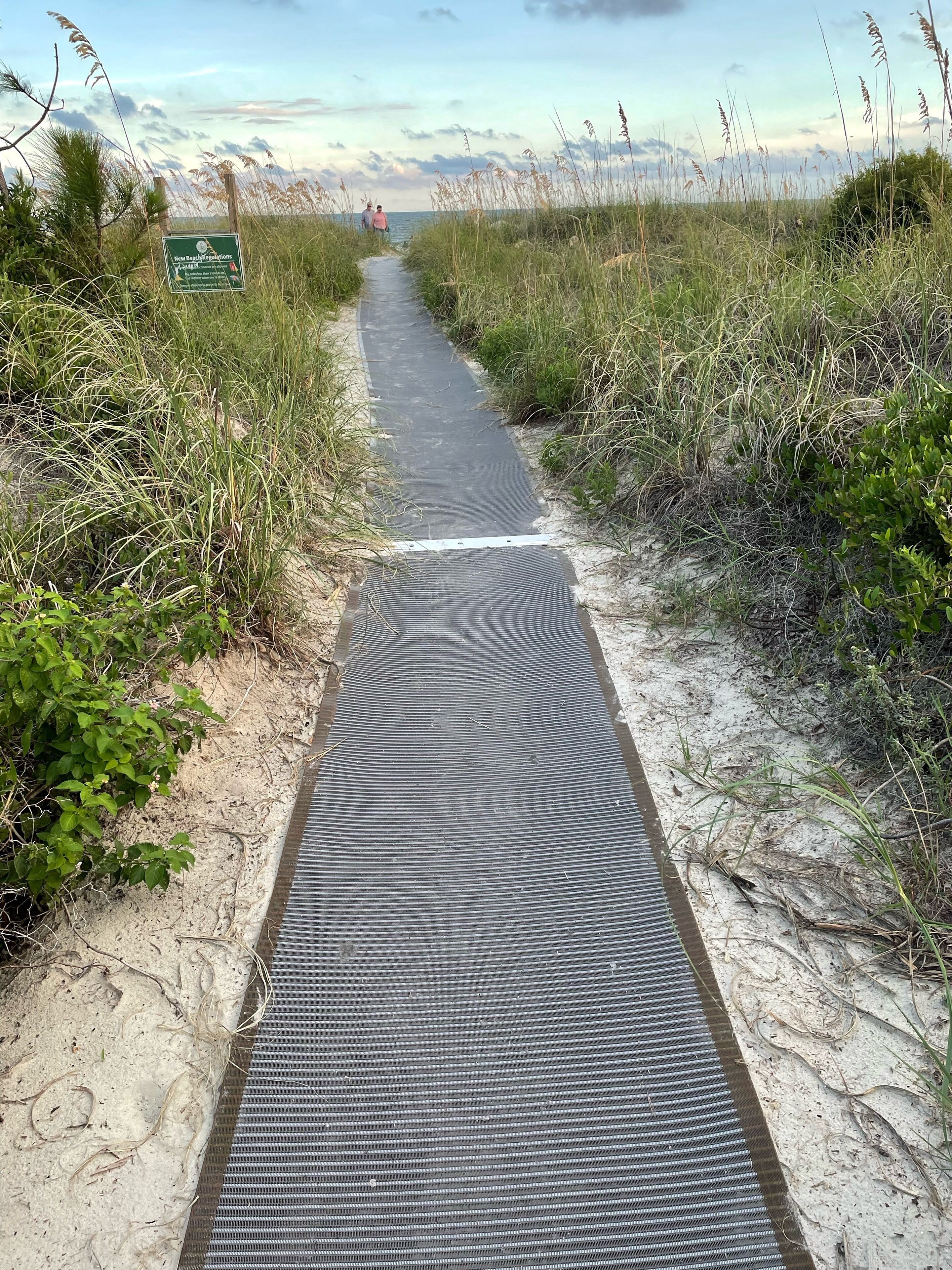A pathway leading to a beach with a sign indicating 'How to Beachgoals'.