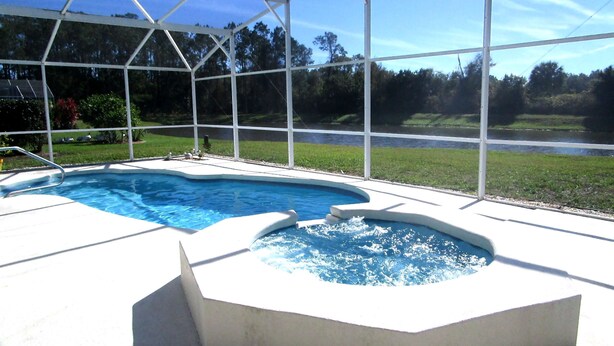 A swimming pool with a hot tub under a covered area. - 'Lakeside Haven'  Fantastic South Facing Pool, Spa and Stunning Lakeside Views. (Kissimmee)