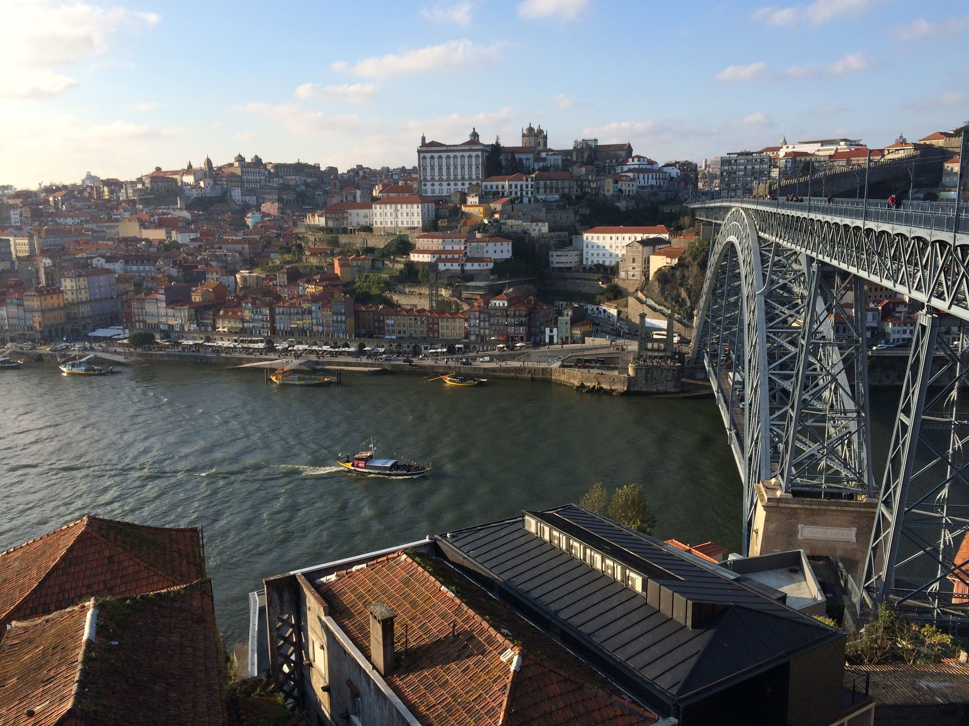 A cityscape with a prominent bridge, historic buildings, and a river.