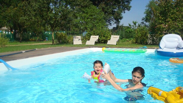 A swimming pool with clear blue water, surrounded by trees and a grassy area. - THE ROOM OF MEUNIER breakfast, accès piscine (Laiz)