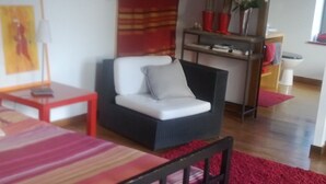 A room with a bed, a sofa, a small table, a chair, a desk, and a window. - THE ROOM OF MEUNIER breakfast, accès piscine (Laiz)