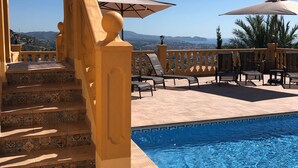 A pool area with a staircase leading to a terrace, outdoor seating, and a view of the landscape. - Beautiful villa with private pool and exceptional sea views. VT-513857-A (Calpe)