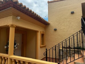 A building with a yellow facade, a tiled roof, and a black metal staircase. - Beautiful villa with private pool and exceptional sea views. VT-513857-A (Calpe)