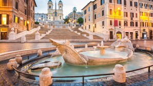 A historic square with a central fountain, a staircase leading to a bell tower, and surrounding classical architecture. - Lilli Home Holidays Rome San Giovanni NOVEMBER OFFER (Roma)