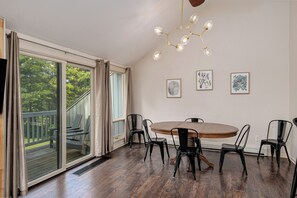 Enjoy a serene view from the deck, featuring a dining area and artworks.