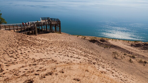 A sandy beach with a wooden viewing platform overlooking the sea. - Beautiful Spacious 3BR/2BA Condo on The Grand Traverse Resort golf course (Williamsburg)