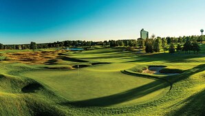 A golf course with bunkers, a flagstick, and a water hazard. - Beautiful Spacious 3BR/2BA Condo on The Grand Traverse Resort golf course (Williamsburg)