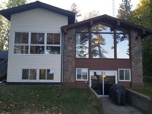A two-story building with a stone facade and large windows. - Unique Air-Conditioned Balsam Lake Waterfront,5 Bedrooms, 3 Baths, Dog friendly. (Kirkfield)