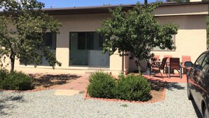 A modern house with a patio, a car, and a tree. - 3  Bedroom Home With Lovely Vigas And Wood Floors - 3.5 Miles To Santa Fe Plaza! (Santa Fe)