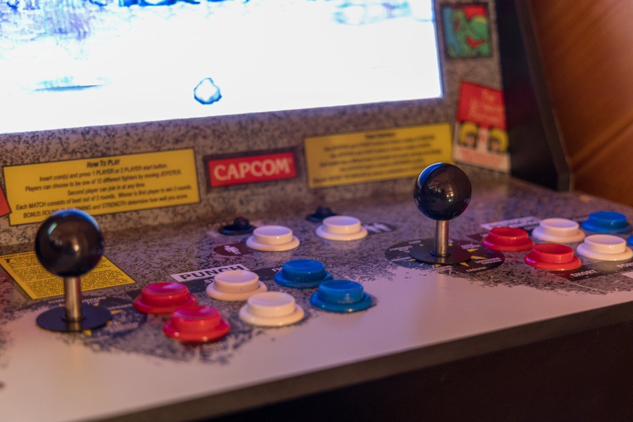 A gaming console with multiple buttons and a screen displaying a game.
