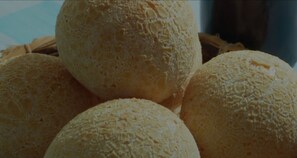 A basket of round, textured bread rolls. - Ágape Hotel (Rio Verde)