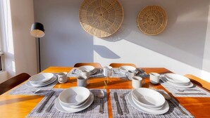 A dining table set with plates, cups, and cutlery, with two wall-mounted decorative items and a floor lamp. - Capitalia | Near to ABC Hospital with Gym/Parking (Ciudad de México)