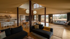 A spacious living area with a kitchen, dining space, and a view of the outdoors. - Abercorn - one of Stayz’s 2025 Holiday Homes of the Year (Buckaroo)