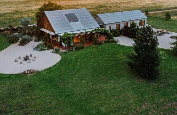 A modern house with a large solar panel roof, a covered porch, and a well-maintained lawn. - Abercorn - one of Stayz’s 2025 Holiday Homes of the Year (Buckaroo)
