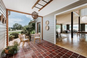 A spacious patio with a tiled floor, wicker furniture, and a view of the outdoors. - Abercorn - one of Stayz’s 2025 Holiday Homes of the Year (Buckaroo)