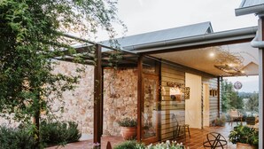 A modern house with a stone exterior, a covered patio with seating, and a view of the countryside. - Abercorn - one of Stayz’s 2025 Holiday Homes of the Year (Buckaroo)