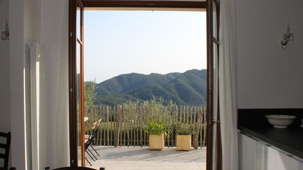 An open doorway to a patio with a view of mountains, a wooden fence, and potted plants. - Lovely greenery detached house with inground private swimming pool.  Large garde (Tresana)