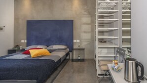 A modern bedroom with a bed, bedside table, and a built-in wardrobe. - Mediceo 42 - Comfort Double Room with Balcony (Pisa)
