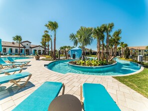 A pool area with lounge chairs, palm trees, and a gazebo. - Windsor at Westside 9050 (Kissimmee)