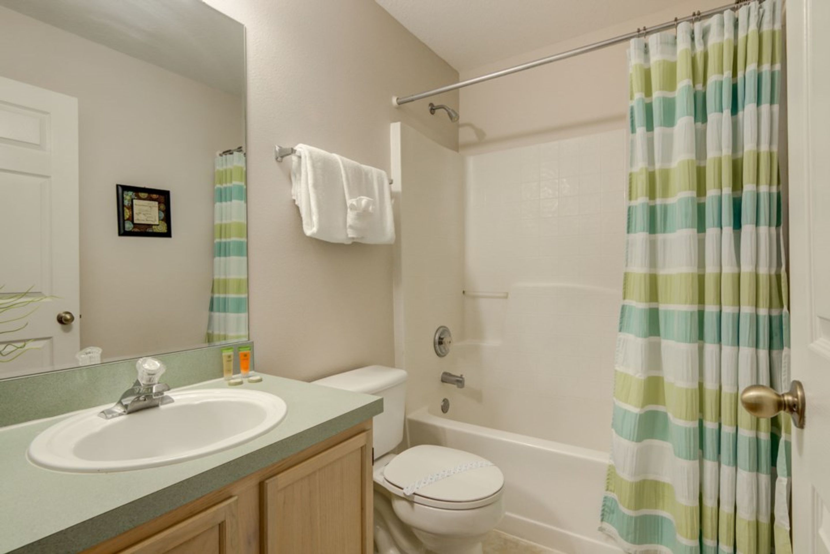 A bathroom with a sink, toilet, and bathtub.