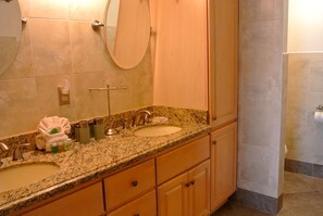 A bathroom with two sinks, a mirror, and a towel rack. - Fort Myers Beach Area 7327 - 302 (Fort Myers Beach)