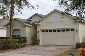A residential house with a garage, number 448, and a brick driveway. - Highlands Reserve Golf & Country Club 448 (Davenport)