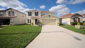 A suburban neighborhood with two-story houses, a well-maintained lawn, and a clear sky. - Four Corners 908 (Davenport)