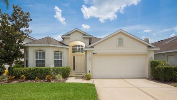 A single-story house with a garage, a front door, and a small front yard with grass and shrubs. - Highlands Reserve Golf & Country Club 349 (Davenport)