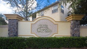 A sign with the text "CLUB Cortile" on a building facade. - Club Cortile 2730b (Kissimmee)