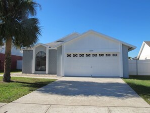 A single-story house with a garage, a small attached garage, and a driveway.
