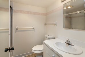 A bathroom with a toilet, sink, and shower. - Bonita Beach 5500 - 2806 (Bonita Springs)