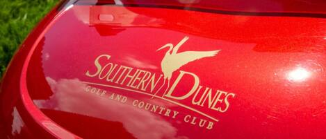 A red vehicle with a logo and text reading "Southern Dunes Golf and Country Club".