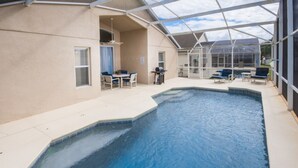 An indoor swimming pool with a glass ceiling, surrounded by lounge chairs and a table. - The Hamlet at Westhaven 320 (Davenport)