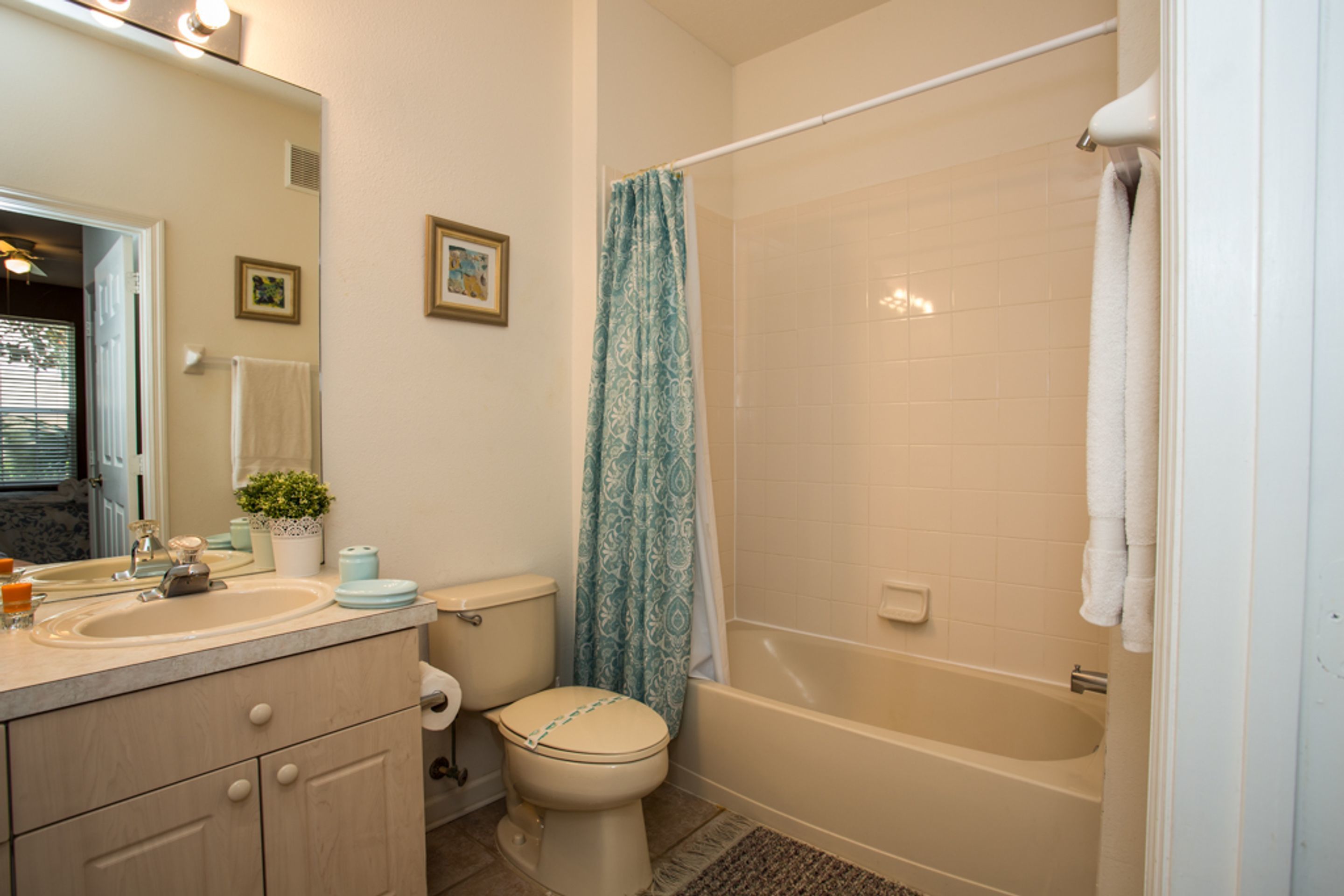 A bathroom with a sink, toilet, and bathtub.