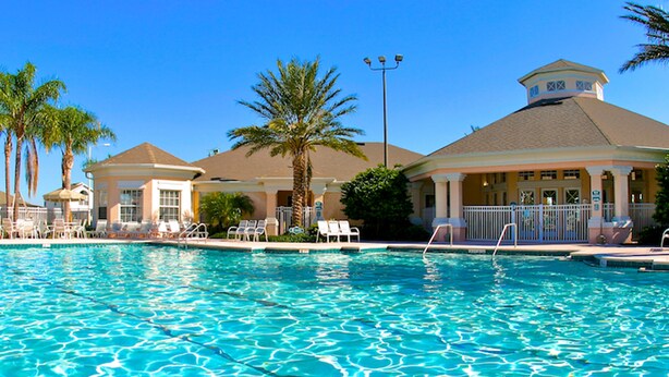 A swimming pool with lounge chairs and palm trees. - Windsor Palms 2200 (Kissimmee)