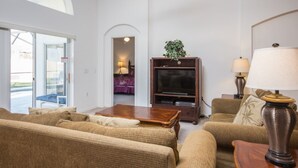A living room with a sofa set, a television, and a lamp. - High Gate Park 204 (Davenport)