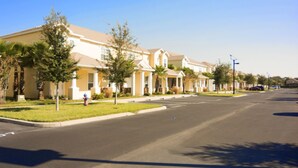 A residential street with houses, a clear sky, and a fire hydrant. - Serenity 17417 B (Clermont)